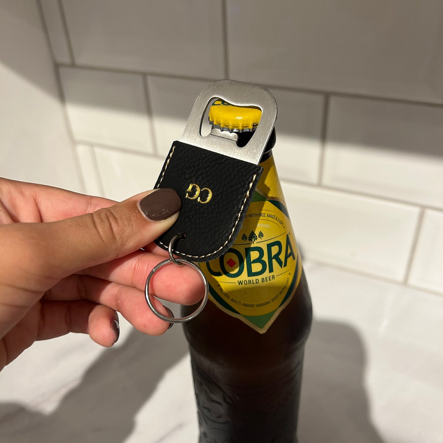 black bottle opener with gold initials