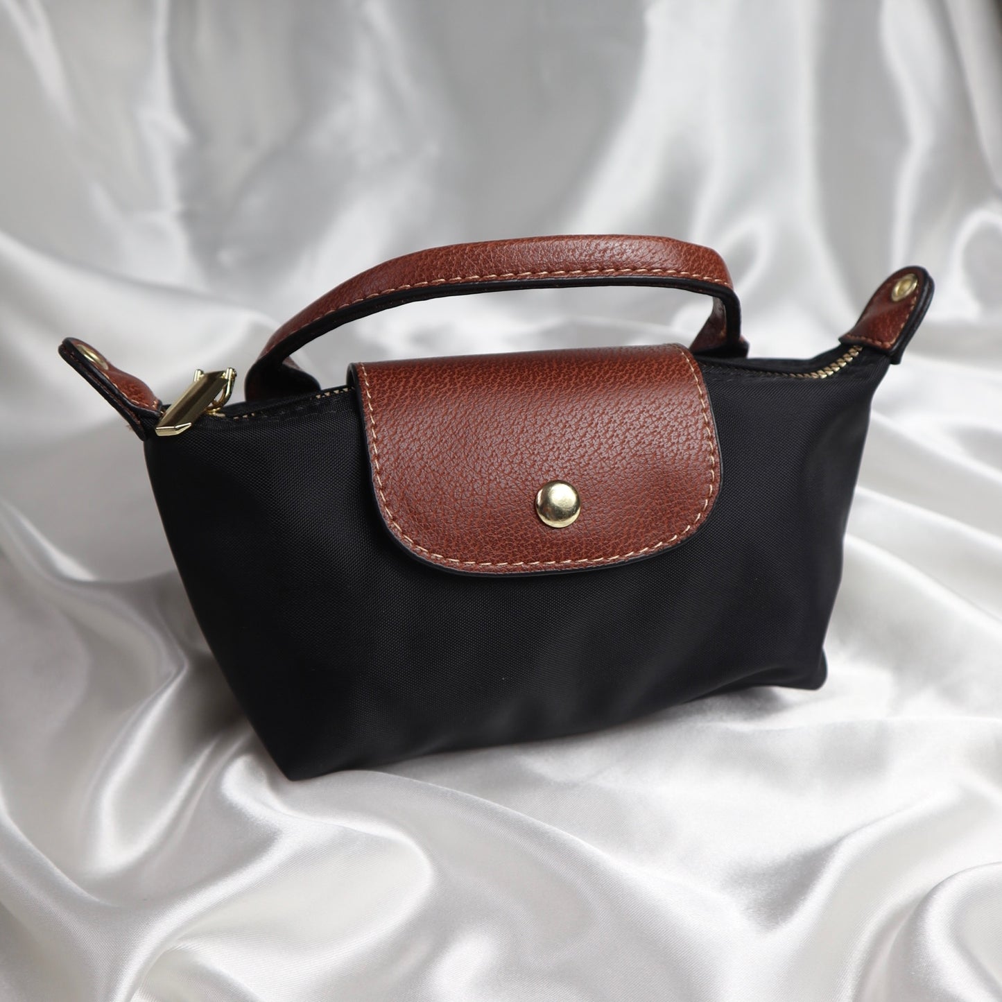 personalised nylon crossbody bag in black which can be customised with initials in gold or silver. comes with adjustable strap