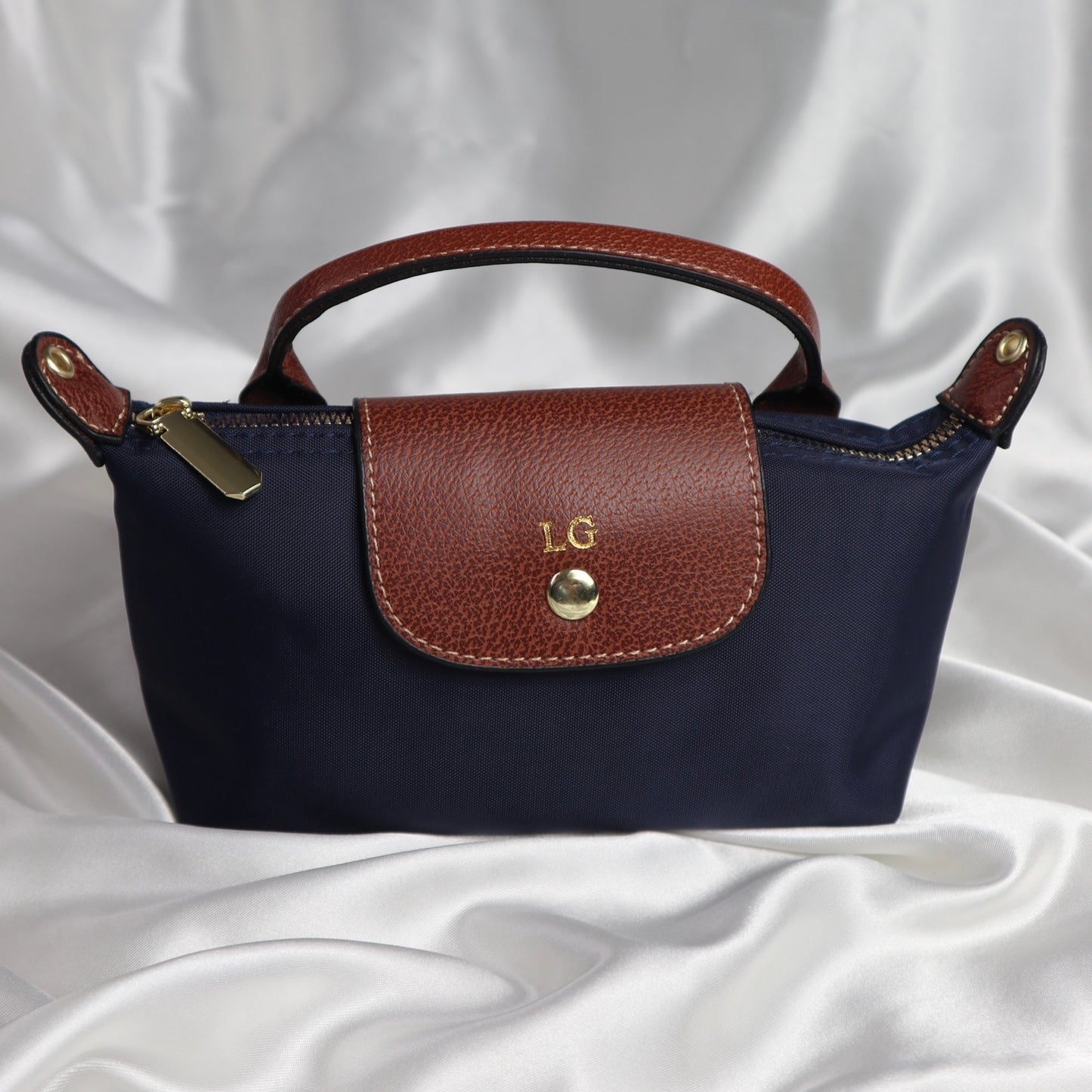 personalised nylon crossbody bag in navy customised with initials in gold. comes with adjustable strap