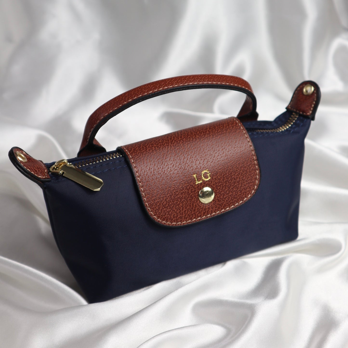 personalised nylon crossbody bag in navy customised with initials in gold. comes with adjustable strap