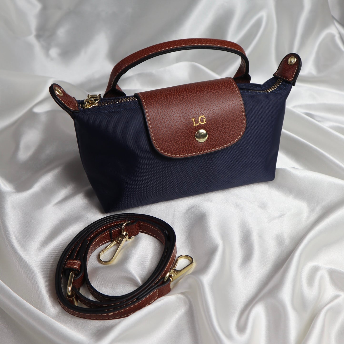 personalised nylon crossbody bag in navy customised with initials in gold with adjustable strap