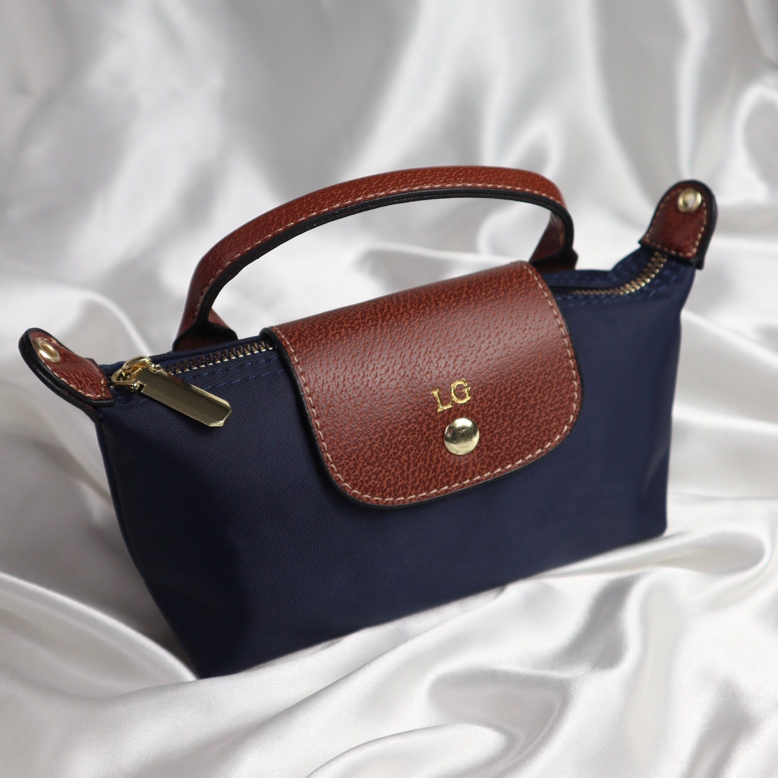 personalised nylon crossbody bag in navy  customised with initials in gold. comes with adjustable strap