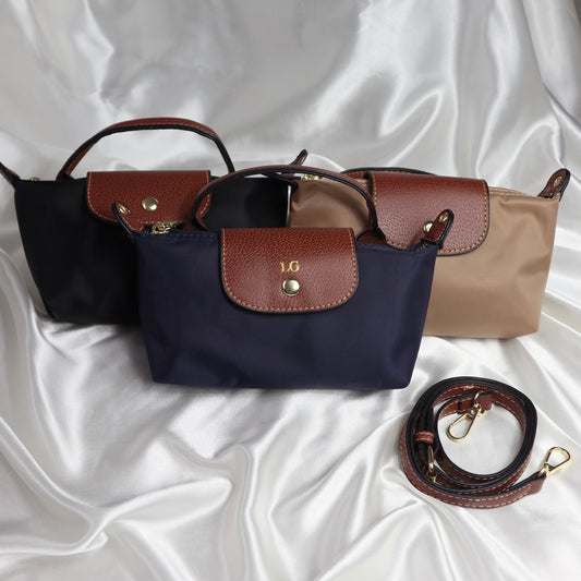 personalised nylon crossbody bags in black, navy and brown, customisable with initials in gold or silver. comes with adjustable strap